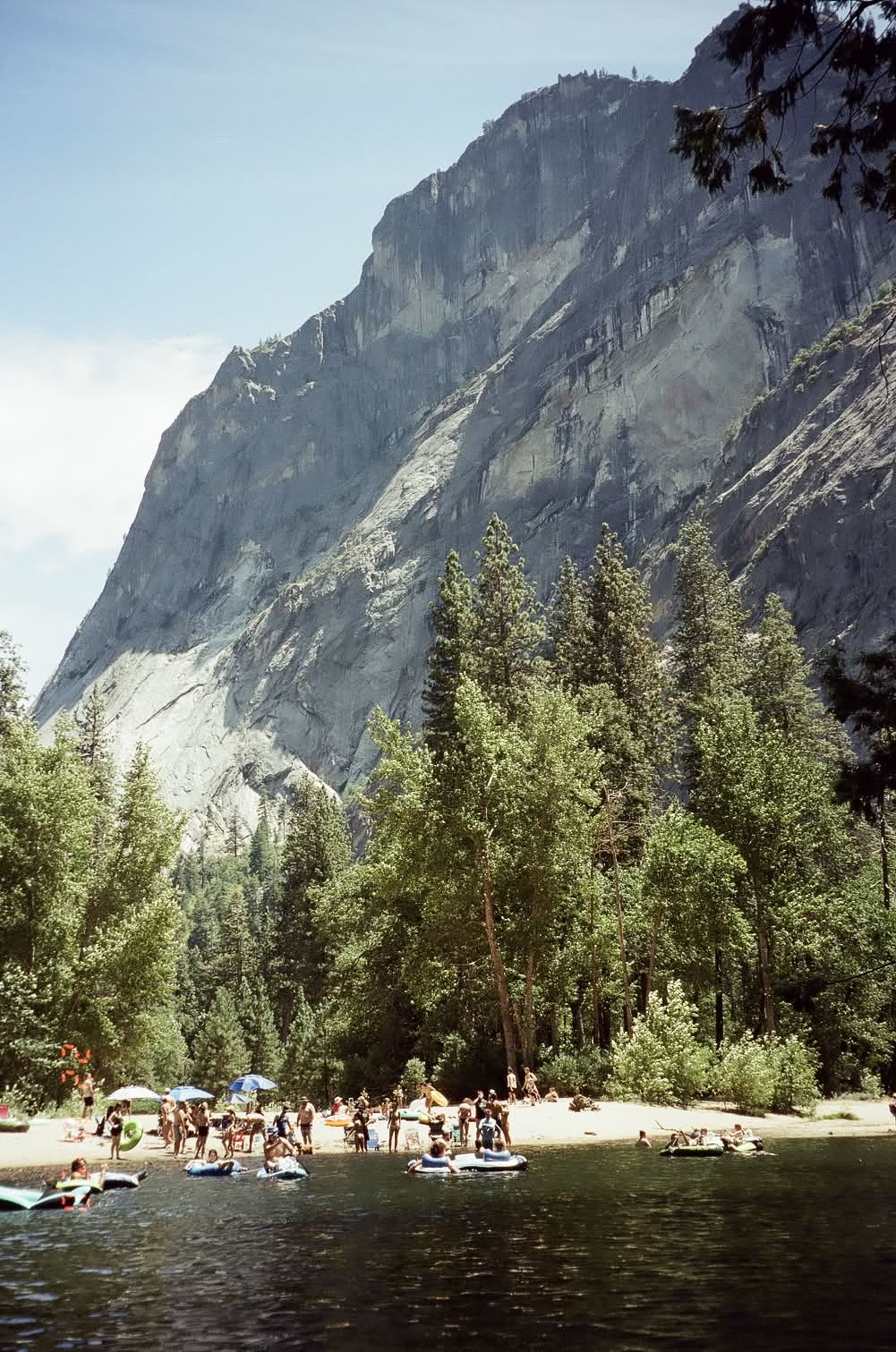 Swimmers along the Merced River beneath a granite cliff, shot on 35mm film